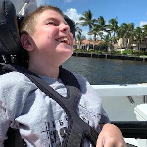 Joshua smiling while enjoying a day on the water